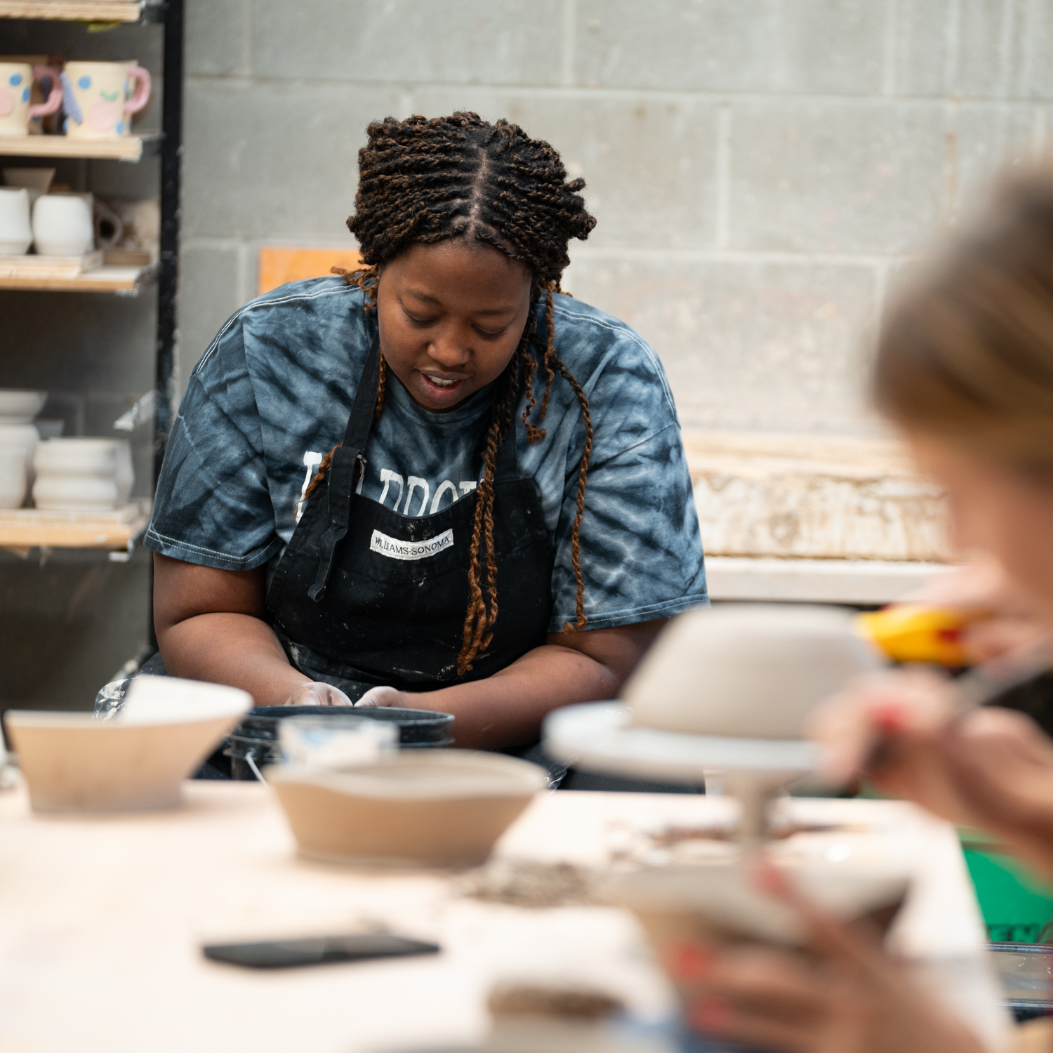 A Co Op Workshop attendee works at a ceramics wheel