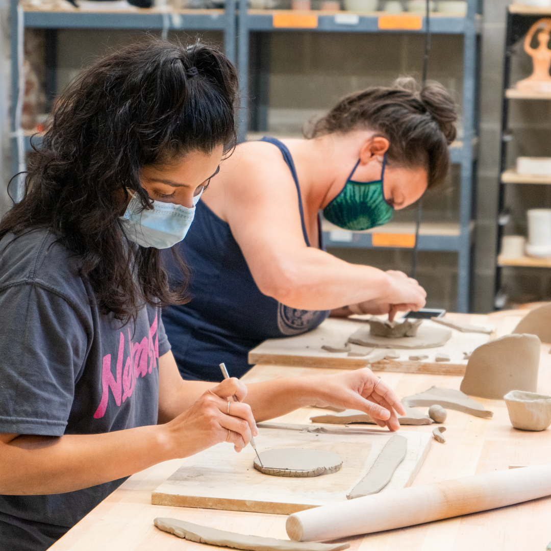 Artists work on clay handbuilding in the ceramics studio