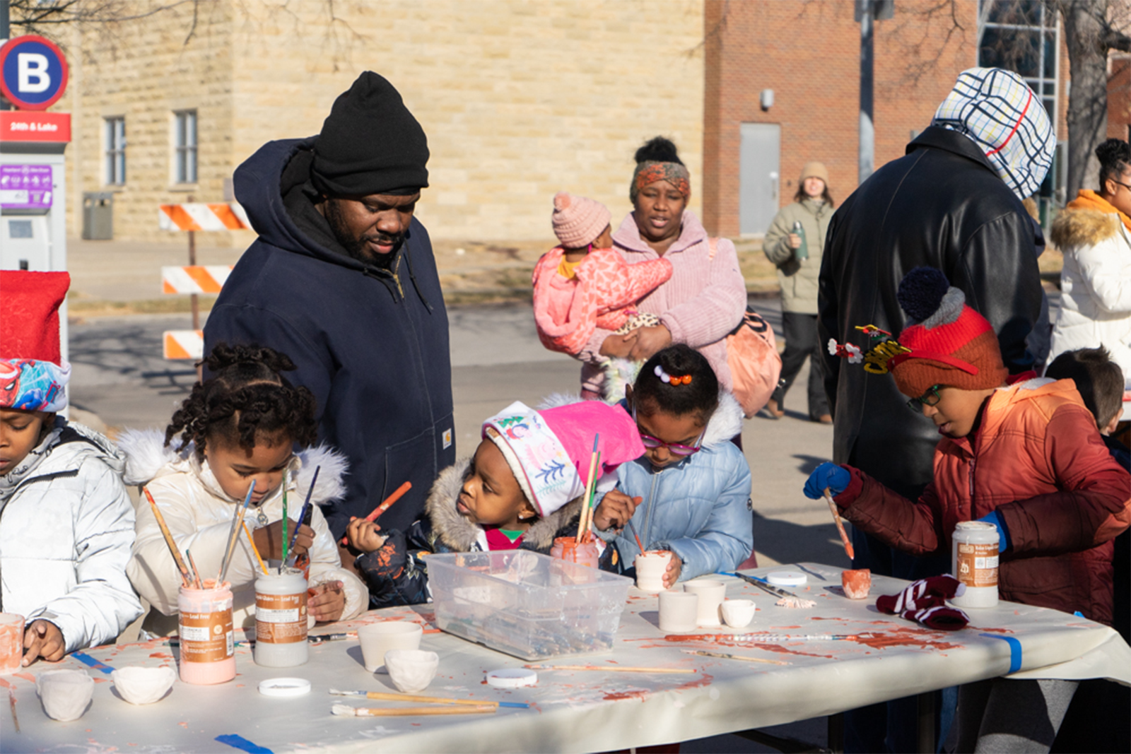 Happenings christmas in the village kids glazing pottery for raku firing